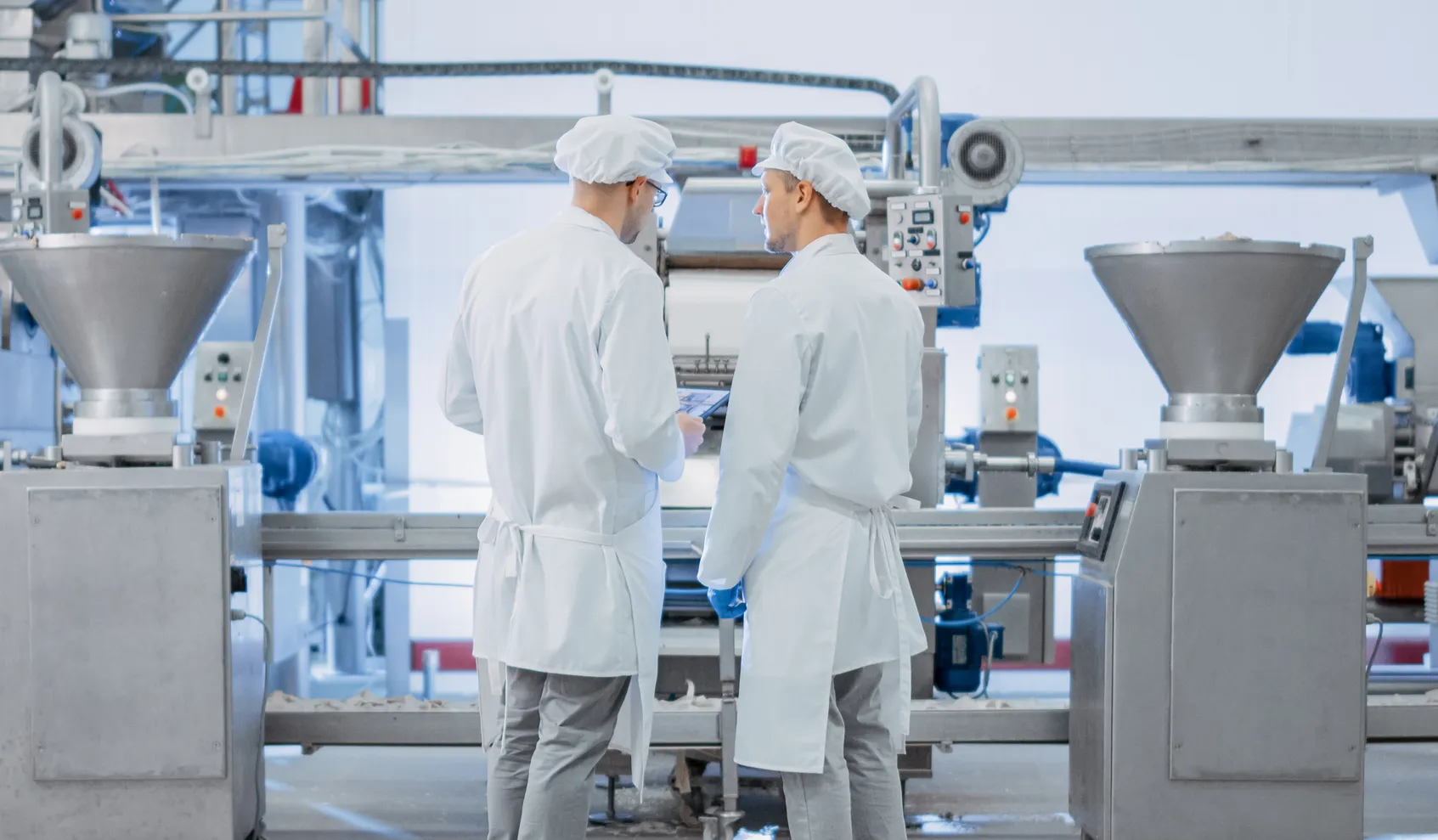 Two hands slicing ham