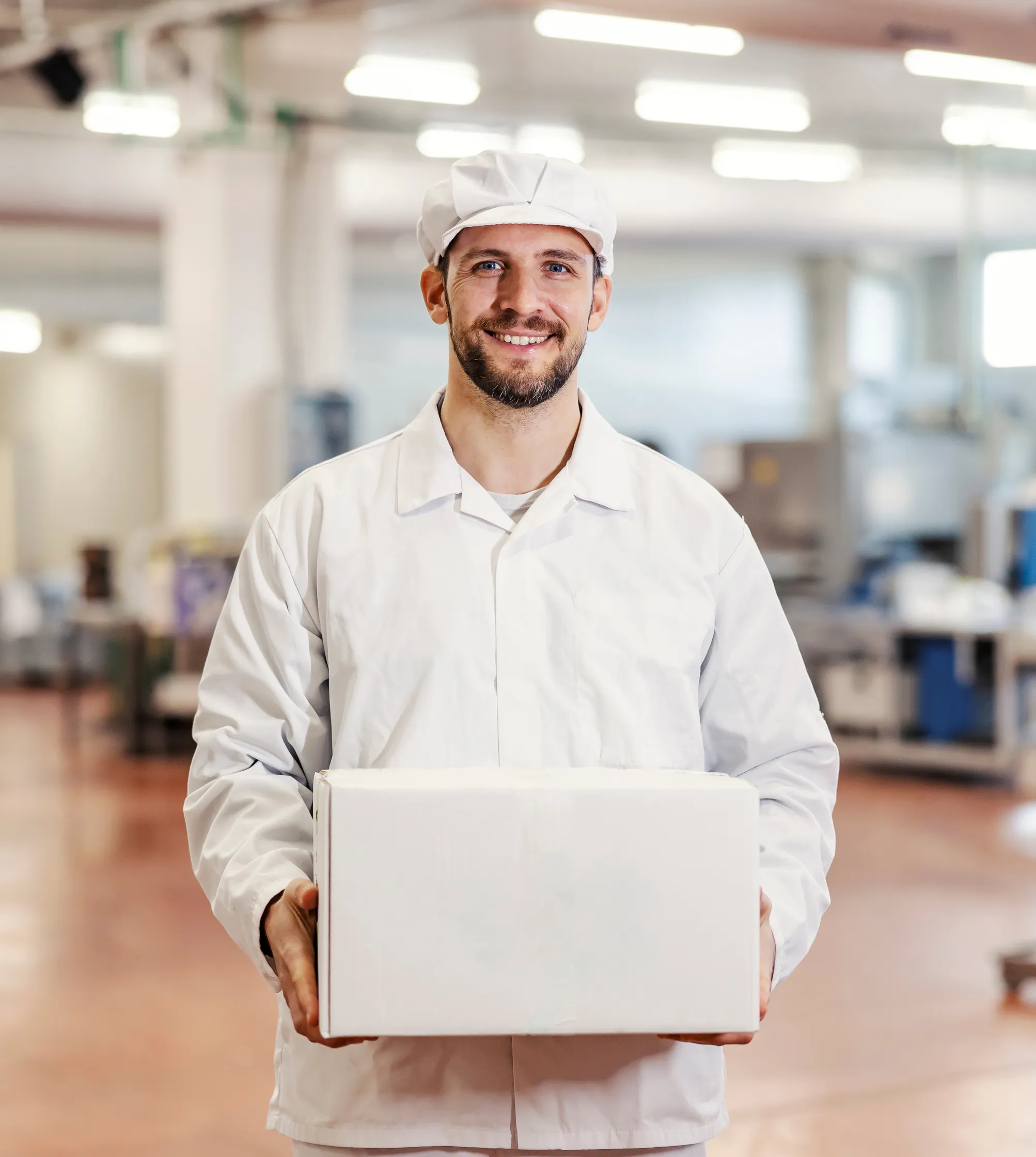 Two hands slicing ham